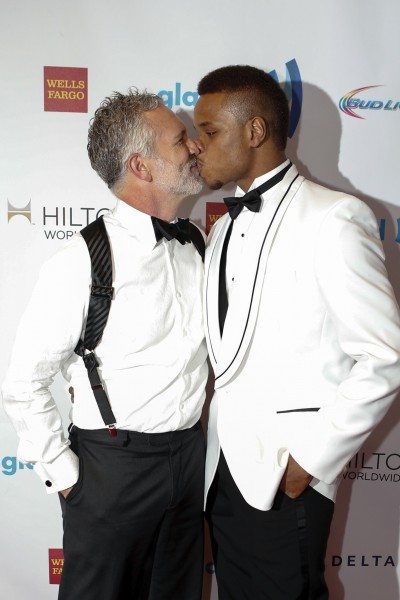 Actor Gerald McCullouch and college basketball player Derrick Gordon kiss during 25th Annual GLAAD Media Awards in New York